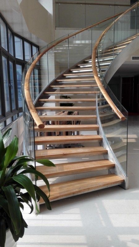 Teak wood stair railing with turned balusters and smooth polished finish